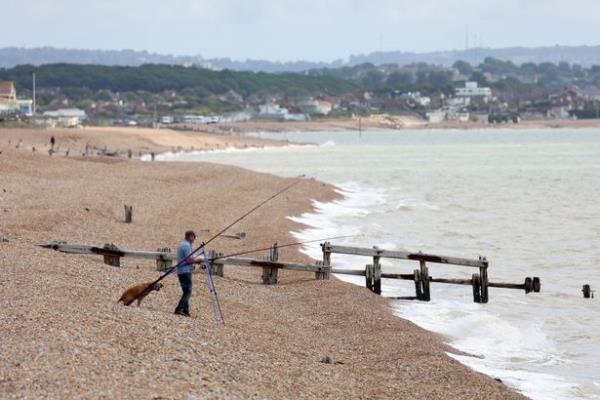 A man fishes in Normans Bay